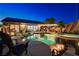 Backyard featuring a luxurious pool, hot tub, fire pit, patio, and lush landscaping at 2333 Indigo Island St, Henderson, NV 89044