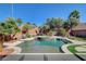Inviting backyard pool and spa with lush landscaping, rock waterfall feature, and plenty of space to relax at 2333 Indigo Island St, Henderson, NV 89044