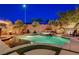Relaxing pool area features mature landscaping, integrated spa and elegant lighting at 2333 Indigo Island St, Henderson, NV 89044
