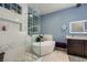 Modern bathroom with a freestanding tub, separate shower and glass block window at 2786 Scotts Valley Dr, Henderson, NV 89052