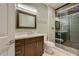 Bathroom featuring a glass shower with tile surround, and a dark wood vanity with a white countertop at 2786 Scotts Valley Dr, Henderson, NV 89052