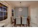 Dining room with decorative lighting, a wood table with upholstered chairs, and a window at 2786 Scotts Valley Dr, Henderson, NV 89052