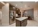 Open kitchen featuring stainless steel appliances, a center island, and a dining area with a modern chandelier at 2786 Scotts Valley Dr, Henderson, NV 89052
