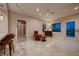 Open living area with tile floors, a leather chair, and large windows offering scenic views at 2786 Scotts Valley Dr, Henderson, NV 89052
