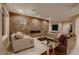 Bright living room featuring stylish sofas, a fireplace, and large windows for ample natural light at 2786 Scotts Valley Dr, Henderson, NV 89052