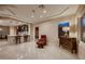 Cozy living space with tile flooring, bar seating, and a comfortable red chair near the window at 2786 Scotts Valley Dr, Henderson, NV 89052