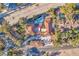 Aerial view of a property featuring a tile roof, circular driveway, pool, and lush landscaping at 2868 Vista Del Sol Ave, Las Vegas, NV 89120