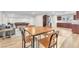 Open basement with a game area, dining space, stainless steel refrigerator, and hardwood flooring at 2868 Vista Del Sol Ave, Las Vegas, NV 89120