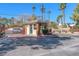 Gated community entrance with a guard house, fountain, mature landscaping, and controlled access for added security at 2868 Vista Del Sol Ave, Las Vegas, NV 89120