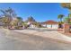 Inviting home exterior with a three-car garage, mature trees, and a spacious driveway at 2868 Vista Del Sol Ave, Las Vegas, NV 89120