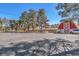 Expansive view showcasing a well-maintained barn and sprawling open space, accentuated by lush trees and clear skies at 2868 Vista Del Sol Ave, Las Vegas, NV 89120