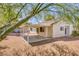 Rear exterior view showcases the covered patio and landscaped yard at 3129 White Rose Way, Henderson, NV 89014