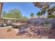 Large backyard has a covered patio, dining set, and privacy fence at 3129 White Rose Way, Henderson, NV 89014