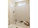 Close up of a white tiled shower with neutral accents and updated fixtures at 3129 White Rose Way, Henderson, NV 89014