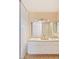 Bathroom with double vanity, white cabinetry, and a large mirror at 3129 White Rose Way, Henderson, NV 89014