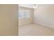An empty bedroom showcasing neutral colors, tile flooring, and a bright ceiling fan at 3129 White Rose Way, Henderson, NV 89014