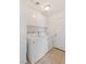 Laundry room with white appliances, white cabinetry, and tiled floors at 3129 White Rose Way, Henderson, NV 89014