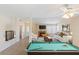 Large, open living space with a pool table and comfortable seating area at 3129 White Rose Way, Henderson, NV 89014