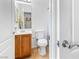 Bright bathroom features a tile floor, oak vanity, white toilet, and shower-tub at 3405 Brook Song Ave, North Las Vegas, NV 89081