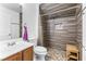 Bathroom features tiled shower with bench, pebble floor, mosaic tile inset, and white vanity at 3405 Brook Song Ave, North Las Vegas, NV 89081