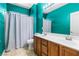Well-lit bathroom with a double sink vanity, toilet, and shower with curtain at 3405 Brook Song Ave, North Las Vegas, NV 89081