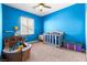 Vibrant bedroom with colorful decor, including playful furniture and a cozy crib at 3405 Brook Song Ave, North Las Vegas, NV 89081