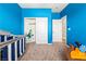 Bright blue bedroom with a closet, crib, and fun decorations creating a cheerful space at 3405 Brook Song Ave, North Las Vegas, NV 89081