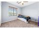 Cozy bedroom with large window providing natural light and a ceiling fan for added comfort at 3405 Brook Song Ave, North Las Vegas, NV 89081