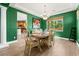 Charming dining room featuring green walls, wood floors, and a window with a garden view at 3405 Brook Song Ave, North Las Vegas, NV 89081