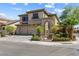 Inviting two-story home boasts a three-car garage and meticulous desert landscaping at 3405 Brook Song Ave, North Las Vegas, NV 89081