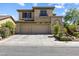 Inviting two-story home boasts a three-car garage and meticulous desert landscaping at 3405 Brook Song Ave, North Las Vegas, NV 89081