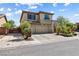 Inviting two-story home boasts a three-car garage and meticulous desert landscaping at 3405 Brook Song Ave, North Las Vegas, NV 89081