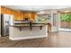 Kitchen features hardwood floors, stainless steel appliances, and a large island with bar seating at 3405 Brook Song Ave, North Las Vegas, NV 89081