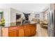 Open concept kitchen and living area features a large island with a stainless steel refrigerator at 3405 Brook Song Ave, North Las Vegas, NV 89081