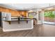 Spacious kitchen with stainless steel appliances, granite counters, and sliding glass door to backyard at 3405 Brook Song Ave, North Las Vegas, NV 89081