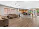 Open living room with hardwood floors, kitchen access, and glass doors to the backyard at 3405 Brook Song Ave, North Las Vegas, NV 89081