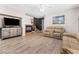 Cozy living room featuring hardwood floors, a fireplace, staircase, and comfortable furniture at 3405 Brook Song Ave, North Las Vegas, NV 89081