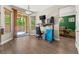 Bright home office space features hardwood floors, a sliding glass door, and an adjustable standing desk at 3405 Brook Song Ave, North Las Vegas, NV 89081
