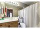 Bathroom with a shower/tub combo, wooden vanity, and neutral color palette at 3425 Yorkminster St, Las Vegas, NV 89129
