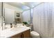 Well-lit bathroom with a modern vanity, decorative shower curtain, and ample storage at 3425 Yorkminster St, Las Vegas, NV 89129