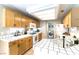 Bright kitchen with white tiled countertops, wood cabinets, and appliances at 3425 Yorkminster St, Las Vegas, NV 89129