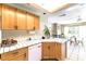 Well-lit kitchen featuring a tiled countertop, wooden cabinetry, and modern appliances at 3425 Yorkminster St, Las Vegas, NV 89129