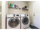 Laundry room with front load machines and ample storage space at 3425 Yorkminster St, Las Vegas, NV 89129