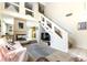 Bright living room featuring a fireplace, staircase, and contemporary decor at 3425 Yorkminster St, Las Vegas, NV 89129