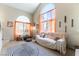 Comfortable living room featuring tall windows, stylish decor, and ample seating at 3425 Yorkminster St, Las Vegas, NV 89129