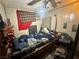 Cluttered bedroom with paneling featuring a bed and a ceiling fan at 3505 W Bonanza Rd, Las Vegas, NV 89107