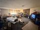 A living room area featuring a brick fireplace, carpeted floors and minimal furnishings, providing a blank canvas at 3505 W Bonanza Rd, Las Vegas, NV 89107