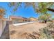 Large backyard with a spacious concrete patio and mature trees at 3604 Cantura Crest Ct, North Las Vegas, NV 89031