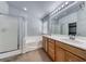Bathroom featuring double sinks, a shower with glass doors, and a soaking tub at 3604 Cantura Crest Ct, North Las Vegas, NV 89031