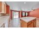 Bright kitchen with tile floors, center island, ample cabinet space, and sliding glass door to backyard at 3604 Cantura Crest Ct, North Las Vegas, NV 89031